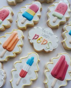 decorated cookies with ice cream and popsicles on them are displayed for the guests to enjoy