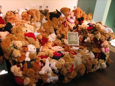 a pile of stuffed animals sitting on top of a wooden floor