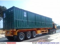 a large green truck is parked on the side of the road