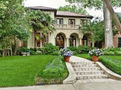 a large house with lots of trees and bushes