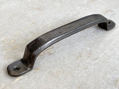 an old metal handle on a white surface