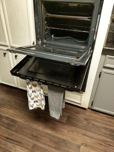 an open oven in the middle of a kitchen