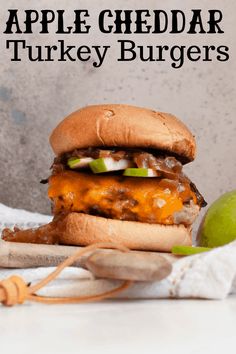 an apple cheddar turkey burger with cheese and pickles