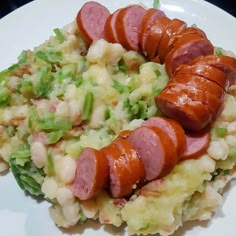 a white plate topped with hot dogs and mashed potatoes