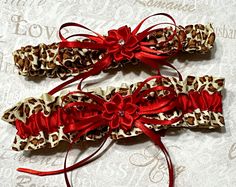 Leopard and red bridal garter set, leopard wedding garters. Lovely set or garters for your leopard print-themed wedding, the perfect way to say you are wild about him. You will get a keepsake and a toss garter. Coordinating accessories shown on second photo are sold separate, see listings or cotact me if you would like to purchase along with this order. ** AT THIS TIME ALL ORDERS TAKE 4-5 WEEKS TO MAKE and SHIP OUT** order accordingly. If you need the items sooner let me know prior to ordering. Cheetah Wedding, Animal Print Wedding, Leopard Wedding, Bridal Garters Set, Wedding Garters, Dance Bag, Bridal Garter, Garter Set, Garters