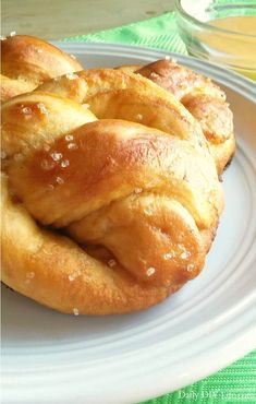 a white plate topped with croissants on top of a table