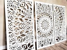 three white laser cut panels on the wall