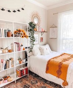 a bedroom with sunflowers and bookshelves on the wall above the bed