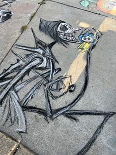 a drawing of a woman's face on the sidewalk