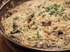 pasta with mushrooms and parmesan cheese in a pan