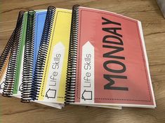 there are five notebooks with the words monday written on them and each one is colored