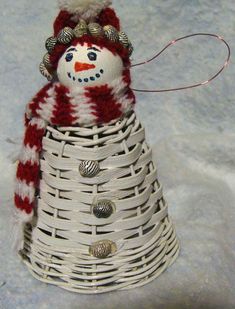 a white basket with a red and white snowman in it