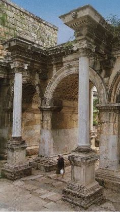 an old stone building with columns and arches