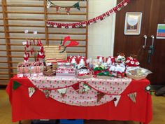 a red table topped with lots of gifts