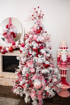 a white and red christmas tree with ornaments