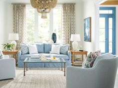 a living room filled with furniture and a chandelier