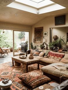 a living room filled with furniture and lots of windows