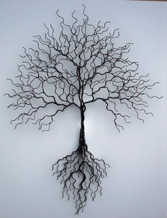 a metal tree with roots hanging from it's sides