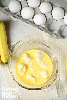 an image of eggs in a bowl and bananas on the table with it's wrapper