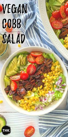 a salad with corn, tomatoes and lettuce in it