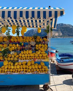 a fruit stand with lemons and oranges for sale