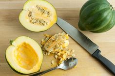 a knife and some cut up squash on a cutting board next to an eggplant