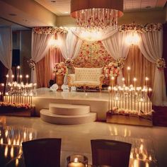 a wedding stage decorated with candles and flowers