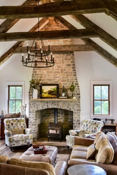 a living room filled with furniture and a fire place in the middle of a room