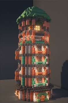 a tall building made out of legos with lights on it's sides and windows