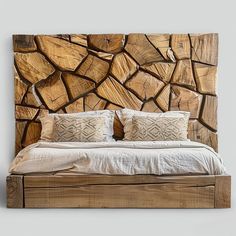 a bed made up with wooden logs on the wall