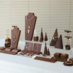 a table topped with lots of wooden jewelry