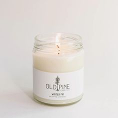 an old pine candle is lit on a white background with the words, winter fir