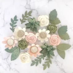 paper flowers are arranged on a marble surface