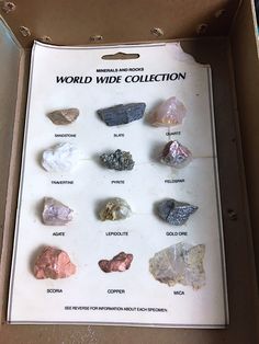 the world wide collection in its box is full of different types of rocks and crystals