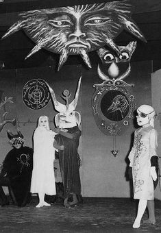 an old black and white photo of people in costumes