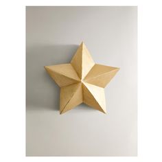 an origami star hanging on the wall