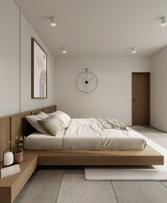 a large bed sitting in the middle of a bedroom next to a wall mounted clock