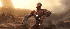 an iron man standing in the middle of a destroyed city with his arms outstretched and eyes closed