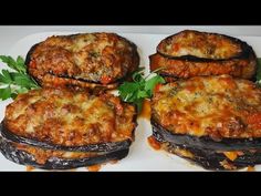 four stuffed eggplant sandwiches on a white plate