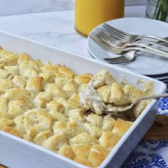 a casserole dish with biscuits and gravy in it on a table