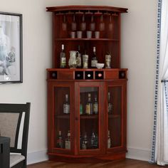 a corner cabinet with liquor bottles on it