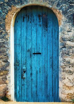 an old stone building with a blue door