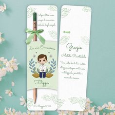 a bookmark with an image of a boy on it next to some white flowers