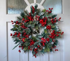 a christmas wreath hanging on the front door