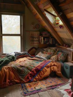 an attic bedroom with a bed, bookshelf and rugs