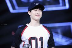 a young man wearing a baseball cap and holding a trophy