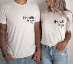 a man and woman standing next to each other wearing t - shirts with the words mr smith on them