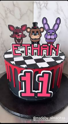 a birthday cake with three cartoon animals on top and the number twenty two in front