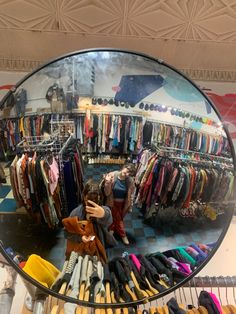 there is a mirror that has clothes in it