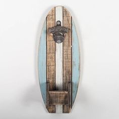 a surfboard mounted to the side of a wall with a coat hook on it